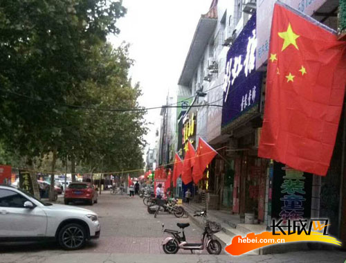 沿街商铺悬挂国旗。王尚武 摄