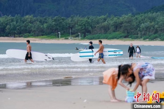 图为10月1日，游客在三亚海棠湾后海体验冲浪。　骆云飞 摄